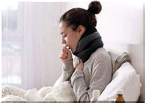 Woman coughing in bed.