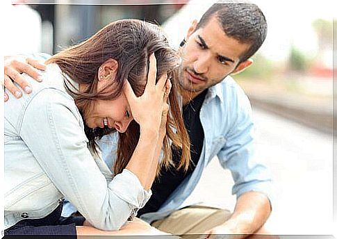 a man comforts a weeping woman