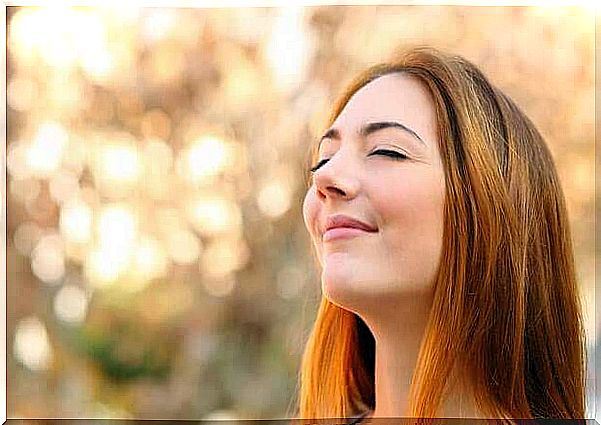 woman smiling with eyes closed